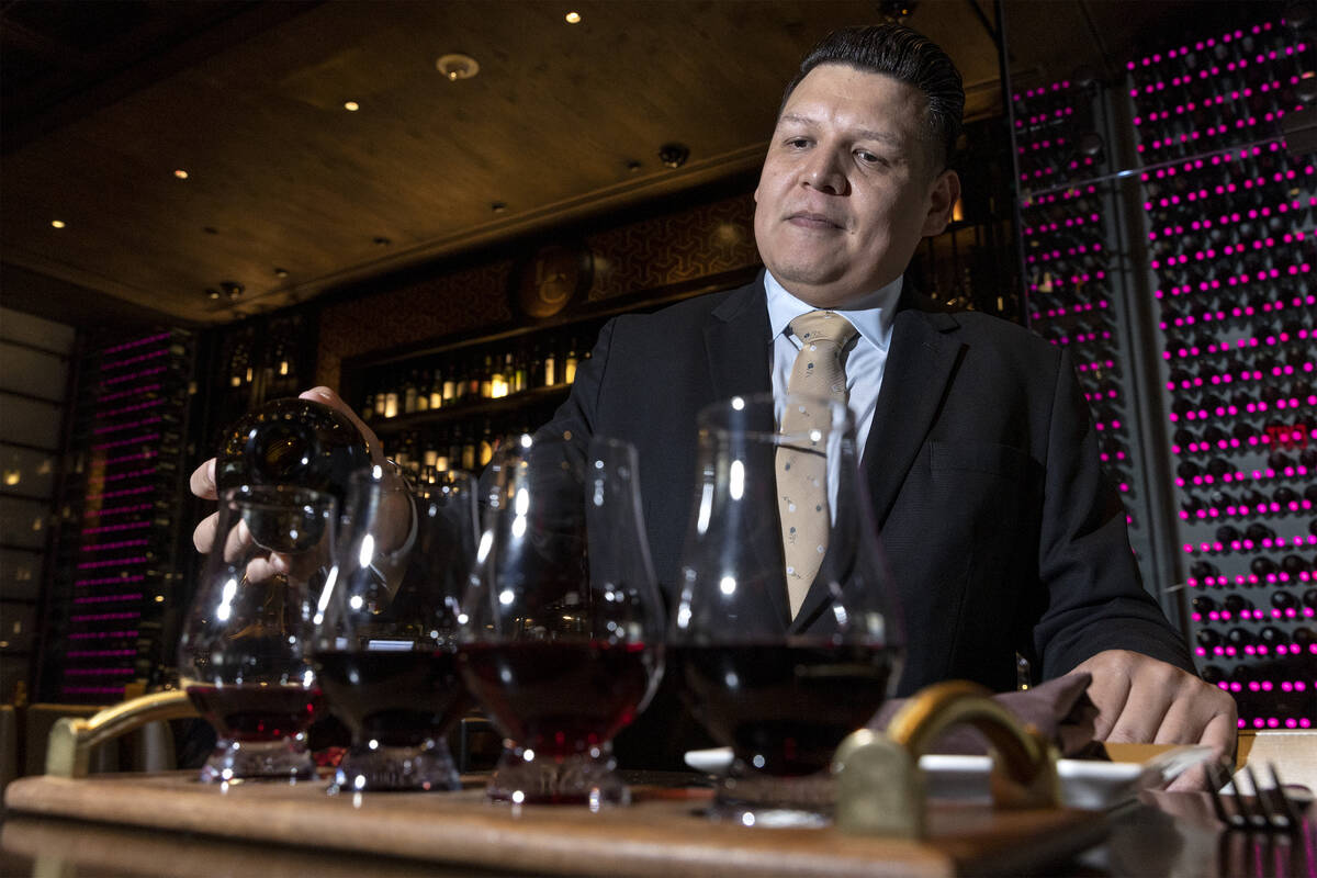 Sommelier Erick Ramirez pours a wine flight at La Cave Wine and Food Hideaway in Wynn Las Vegas ...
