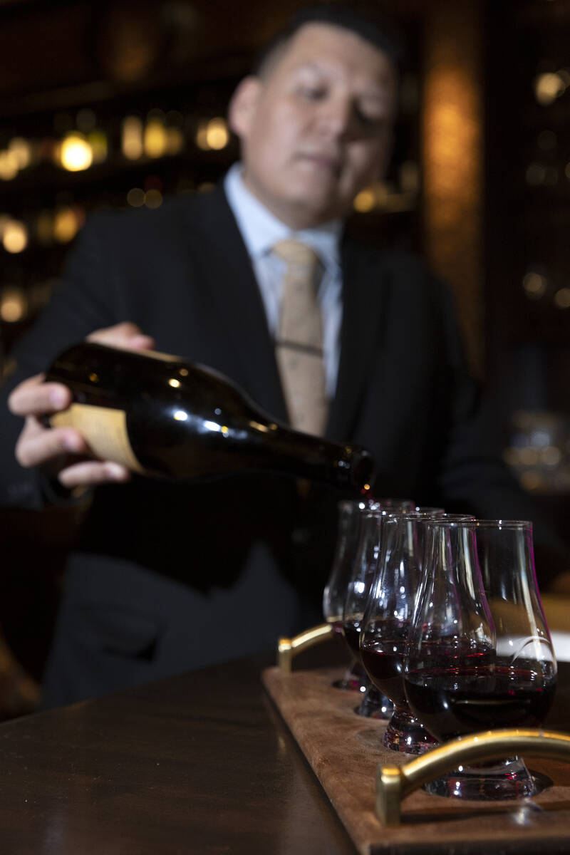 Sommelier Erick Ramirez pours a wine flight at La Cave Wine and Food Hideaway in Wynn Las Vegas ...