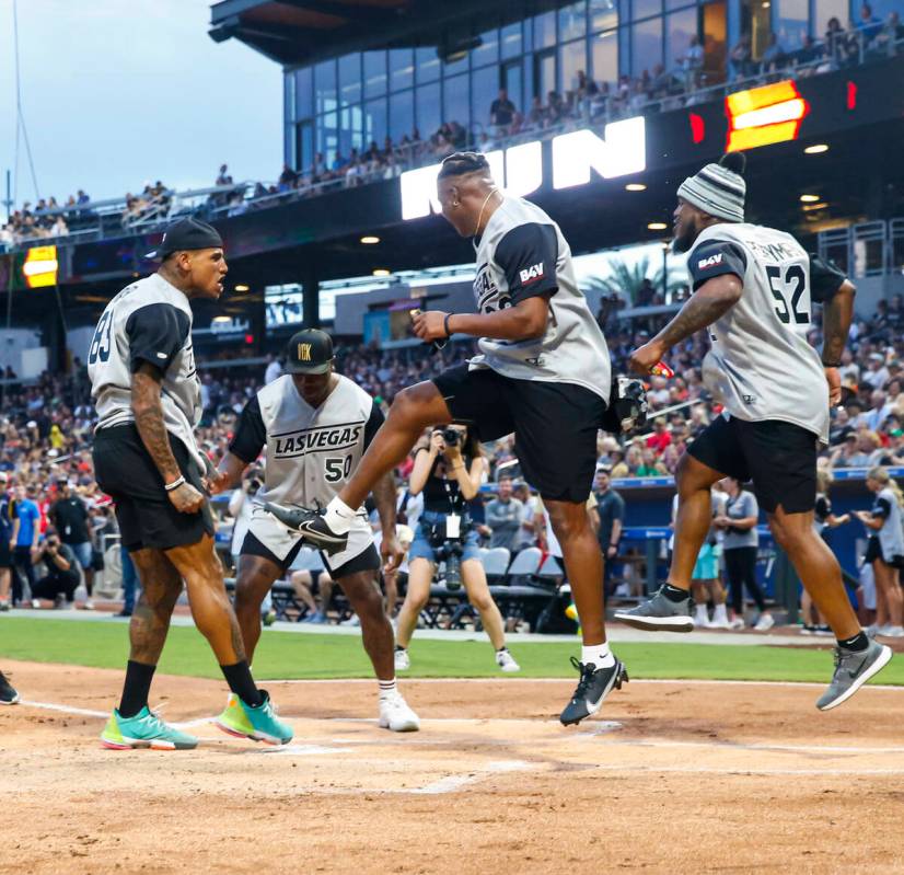 Raiders’ Darren Waller, left, celebrates his home run as, from left, Jayon Brown, Kenyan ...