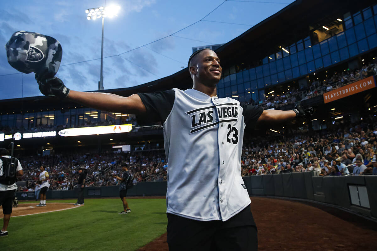 Raiders’ Kenyan Drake reacts to the crowd during the Battle for Vegas charity softball g ...