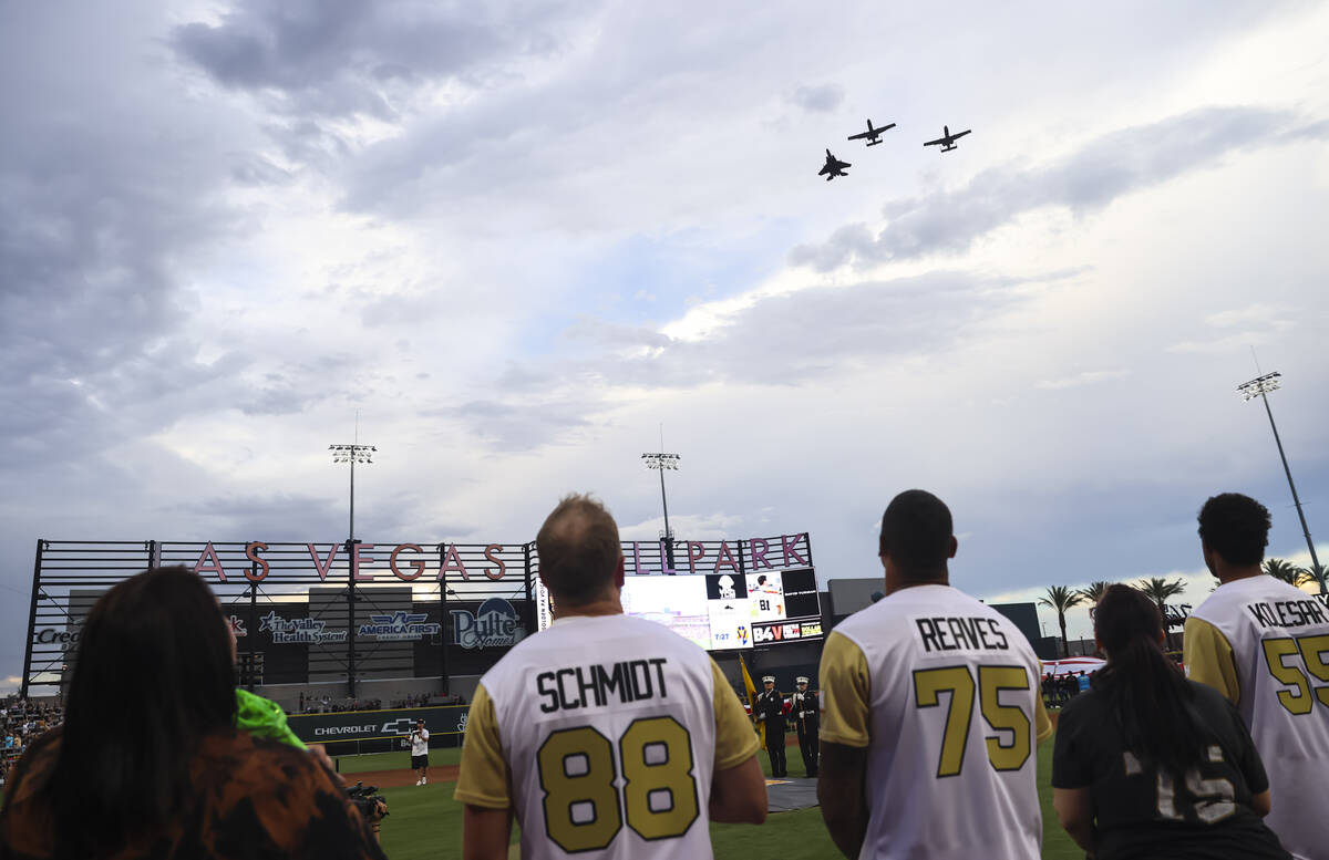 Former Golden Knights players Nate Schmidt and Ryan Reaves watch a flyover before the start of ...
