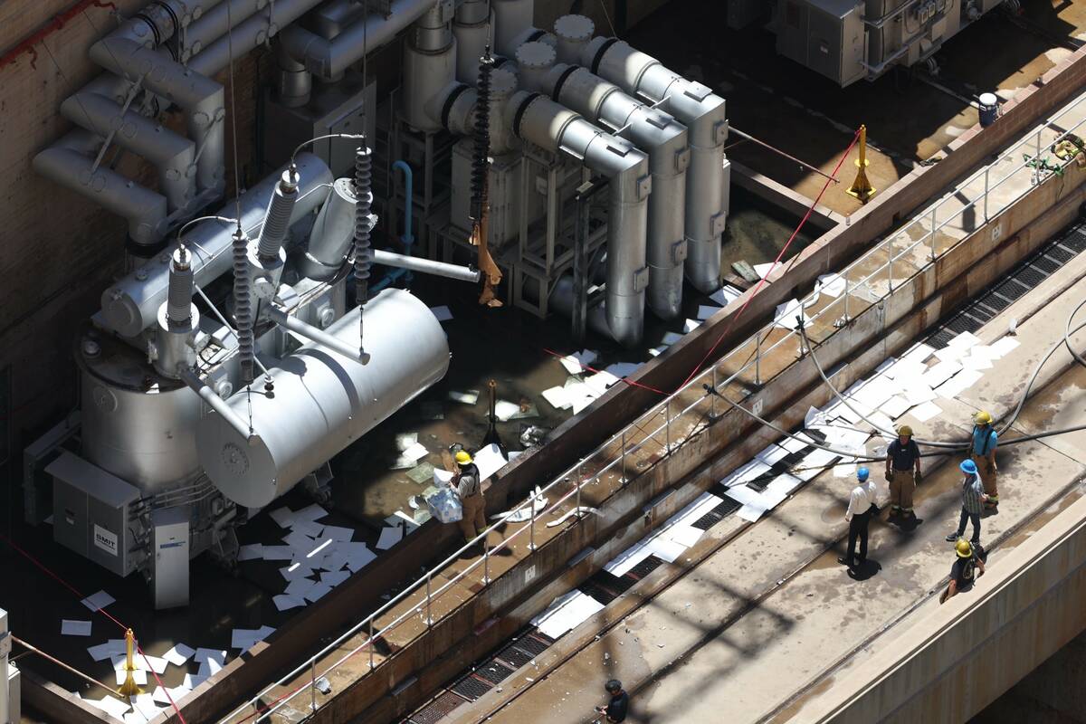 Emergency personnel investigate a transformer that exploded, causing a fire at the Hoover Dam o ...