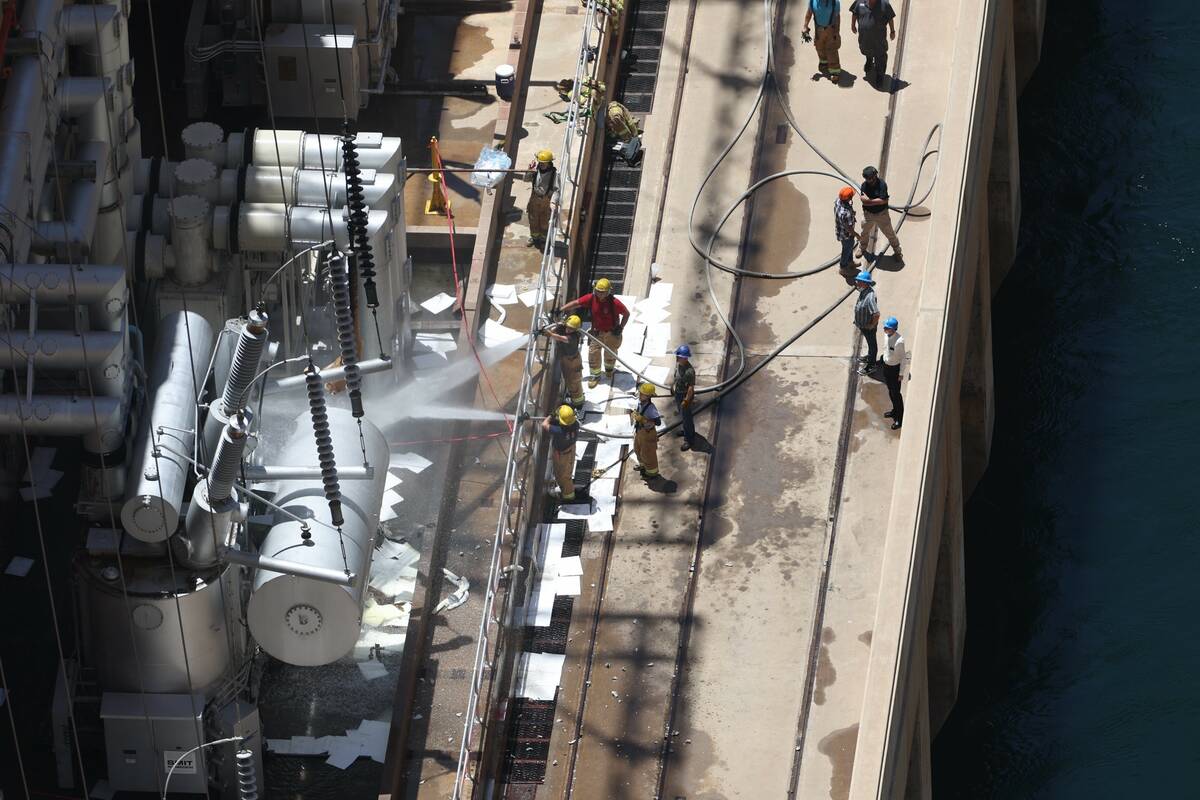 Emergency personnel investigate a transformer that exploded, causing a fire at the Hoover Dam o ...