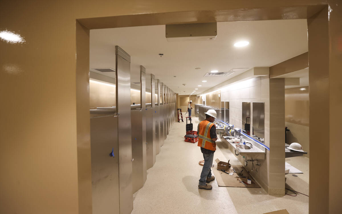 Workers make progress renovating the bathrooms for the emergency overnight men's homeless shelt ...