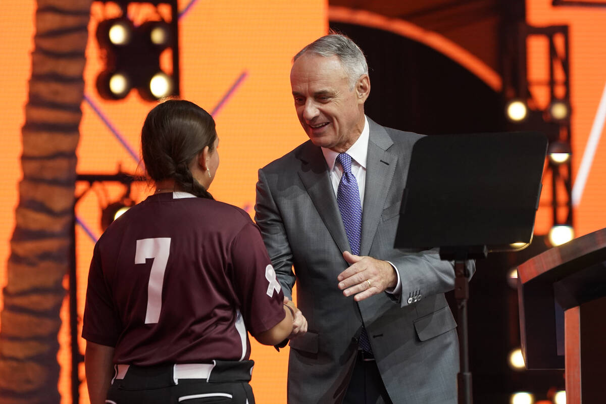 MLB Commissioner Rob Manfred, right, shakes hands with Willa suarez, of Uvalde, Tex., during th ...