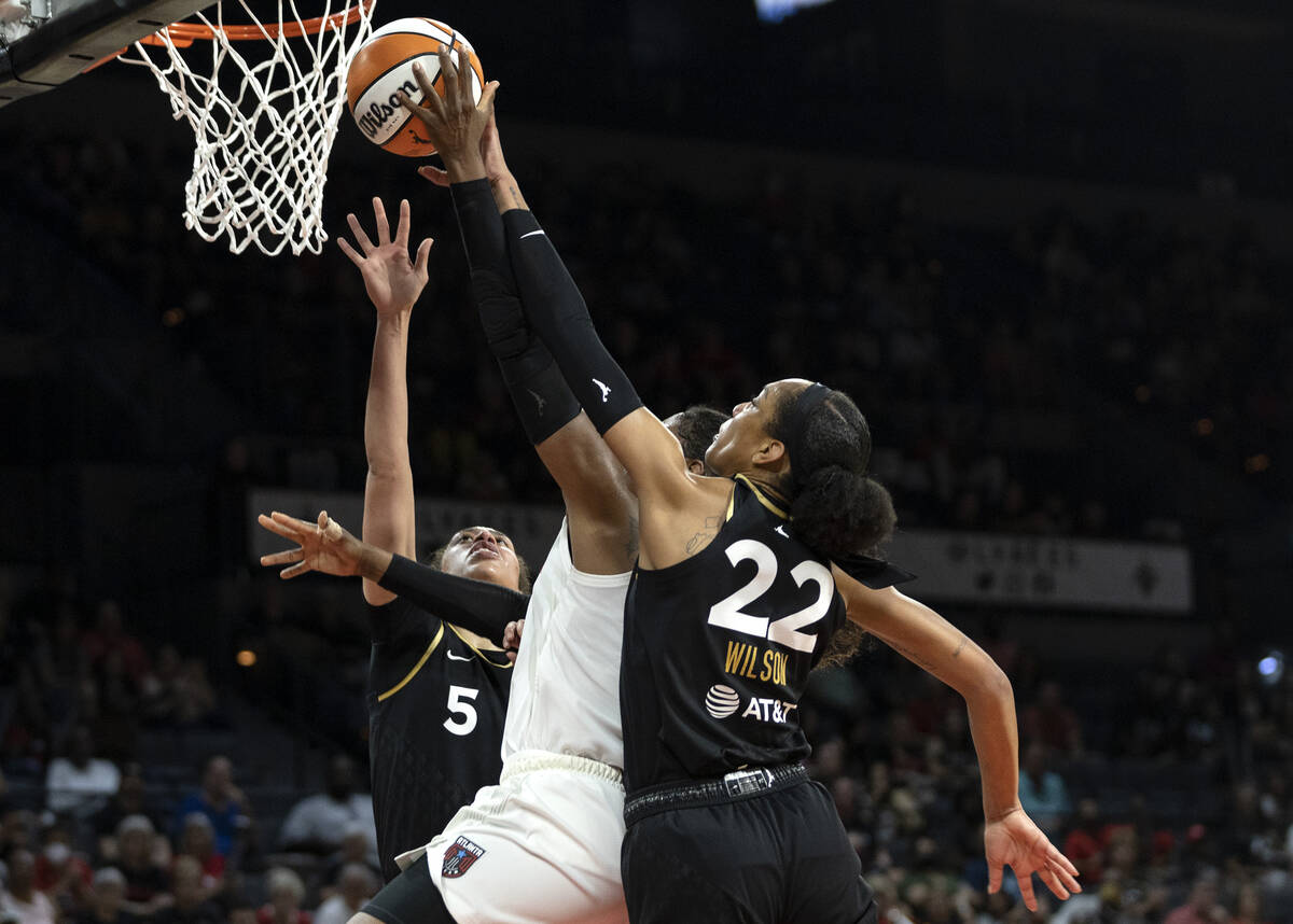 Las Vegas Aces forward A'ja Wilson (22) and forward Dearica Hamby (5) block a shot by Atlanta D ...