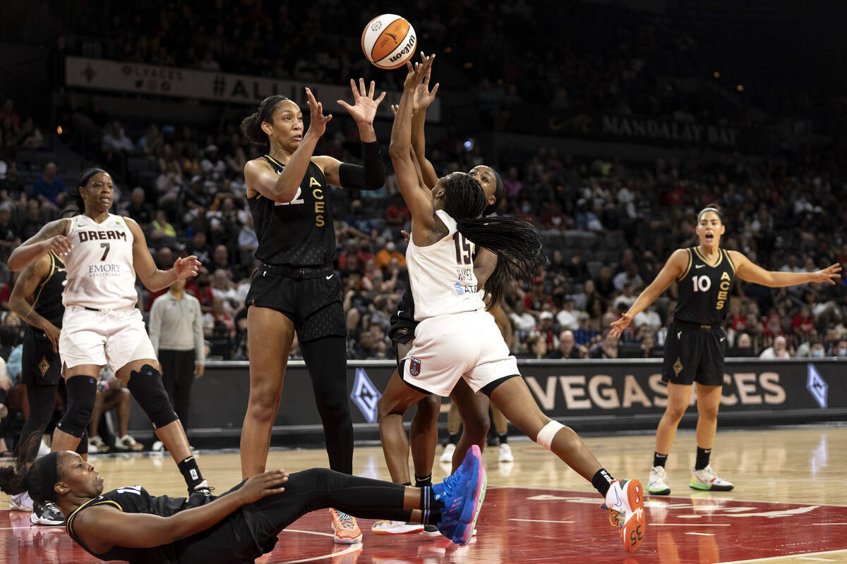 Las Vegas Aces forward A'ja Wilson (22) and guard Jackie Young (0) block a shot by Atlanta Drea ...