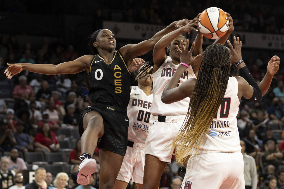 Las Vegas Aces guard Jackie Young (0) loses control of the ball to Atlanta Dream guard Tiffany ...