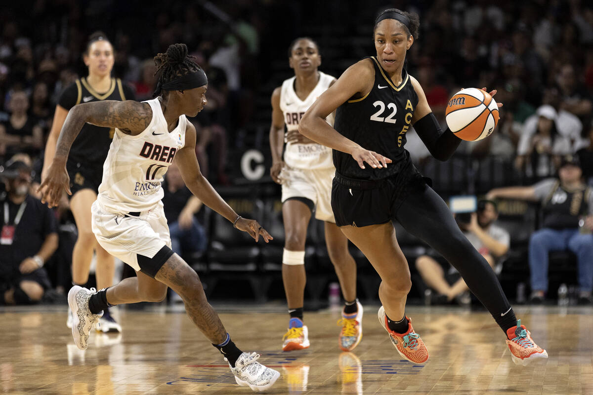 Las Vegas Aces forward A'ja Wilson (22) dribbles past Atlanta Dream guard Erica Wheeler (17) du ...