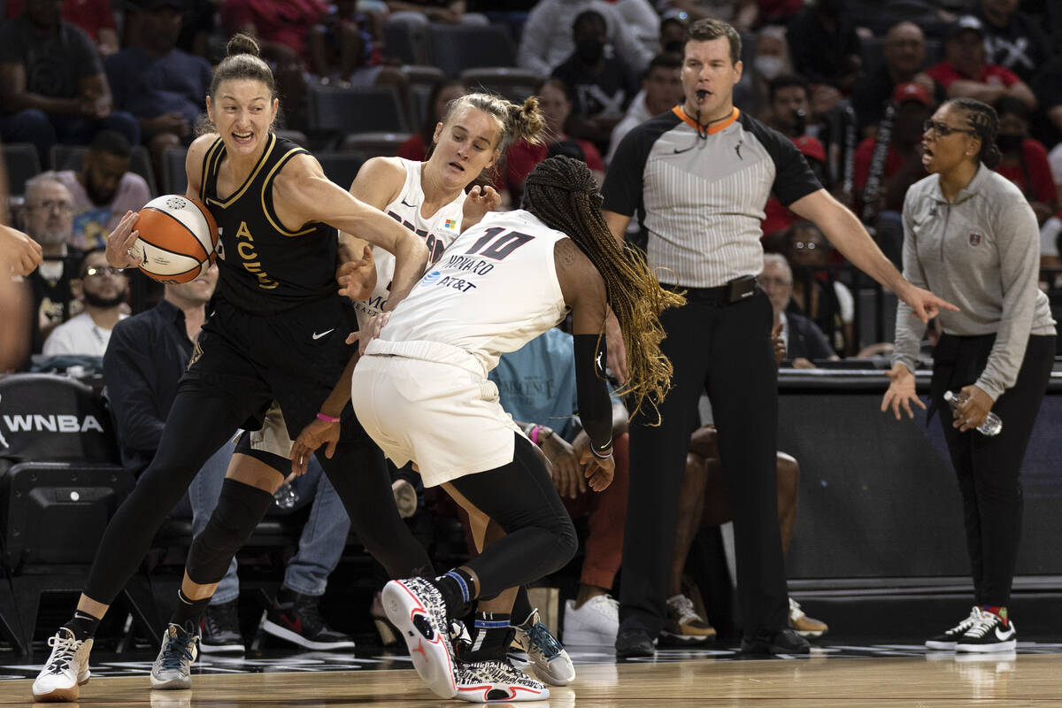Las Vegas Aces forward Theresa Plaisance (55) fights for control of the ball with Atlanta Dream ...