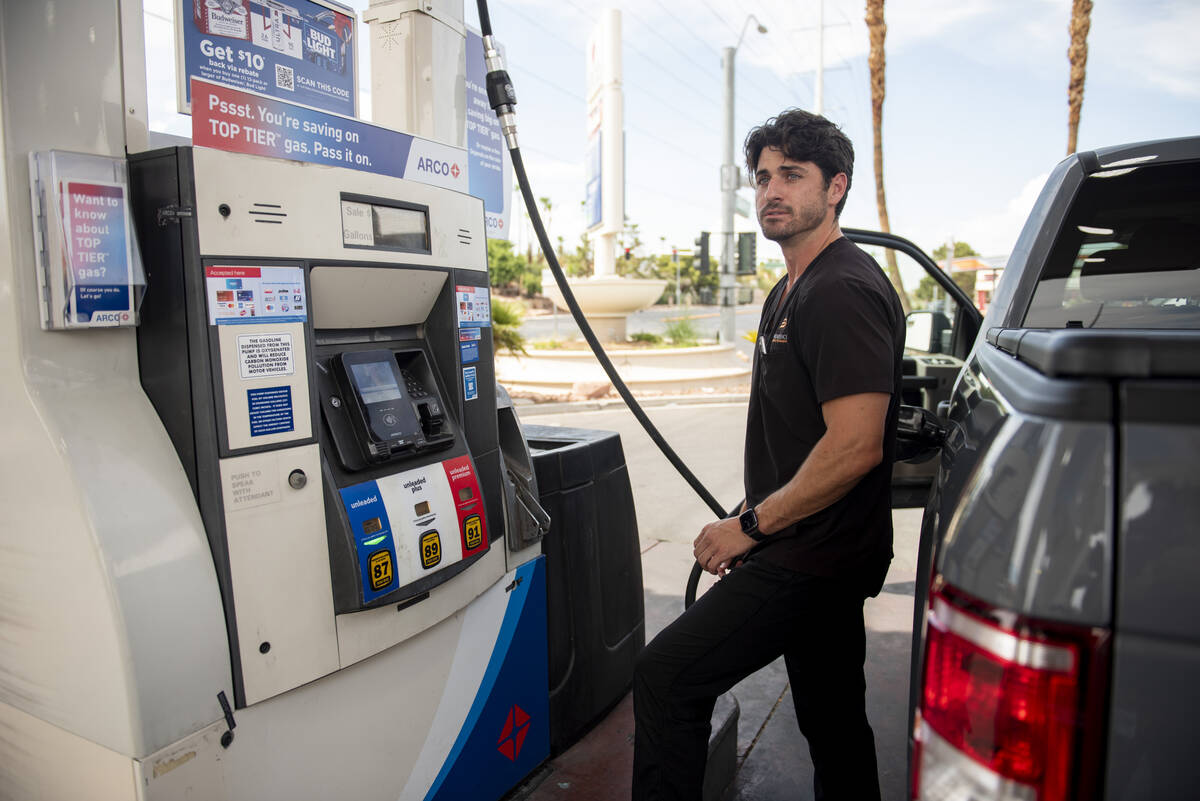 Zachary Kinney pumps gas at an Arco station on West Sahara Ave. on Wednesday, July 20, 2022, in ...