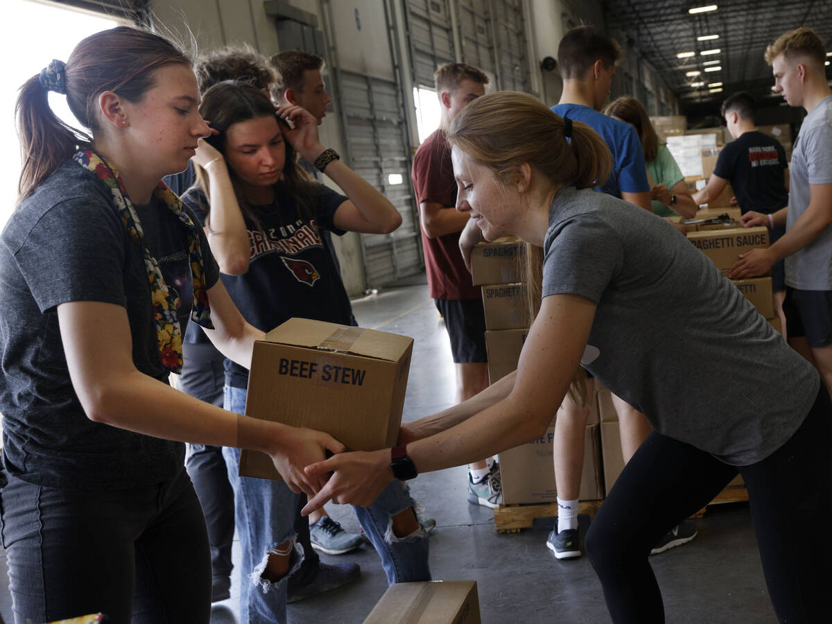 Volunteers from The Church of Jesus Christ of Latter-day Saints, Emma Steed, 18, left, and Laur ...