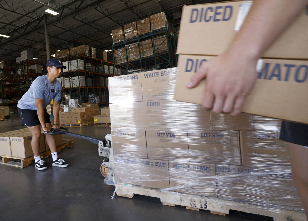 Volunteer Elder Jarim Medina, 19, from The Church of Jesus Christ of Latter-day Saints, moves a ...