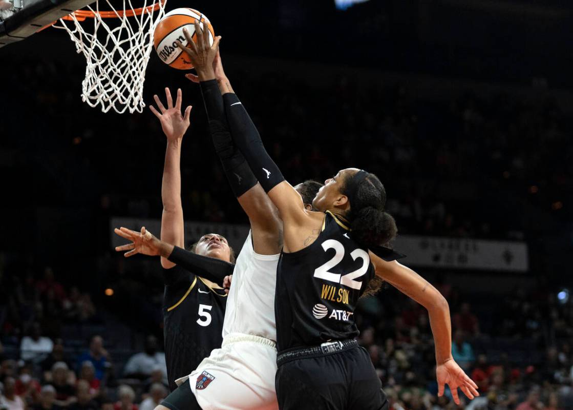 Las Vegas Aces forward A'ja Wilson (22) and forward Dearica Hamby (5) block a shot by Atlanta D ...