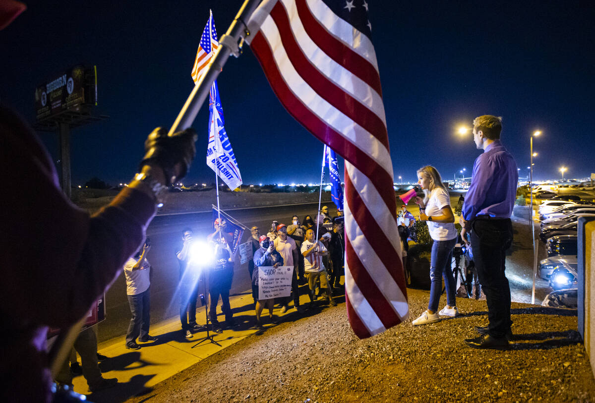 Conservative activist Courtney Holland, center right, speaks to supporters of President Donald ...