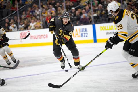 Golden Knights center Brett Howden (21) skates against Bruins defenseman Derek Forbort (28) dur ...