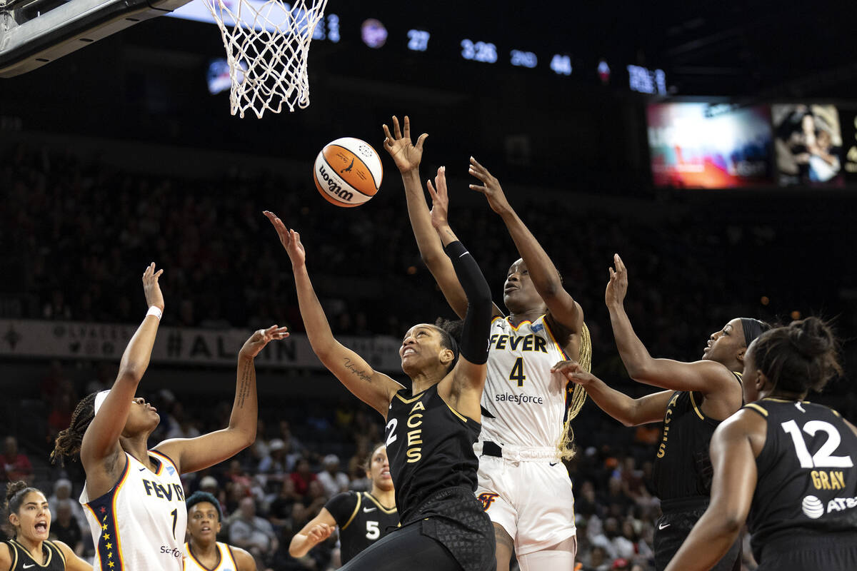 Las Vegas Aces forward A'ja Wilson (22) knocks a shot away from Indiana Fever forward NaLyssa S ...