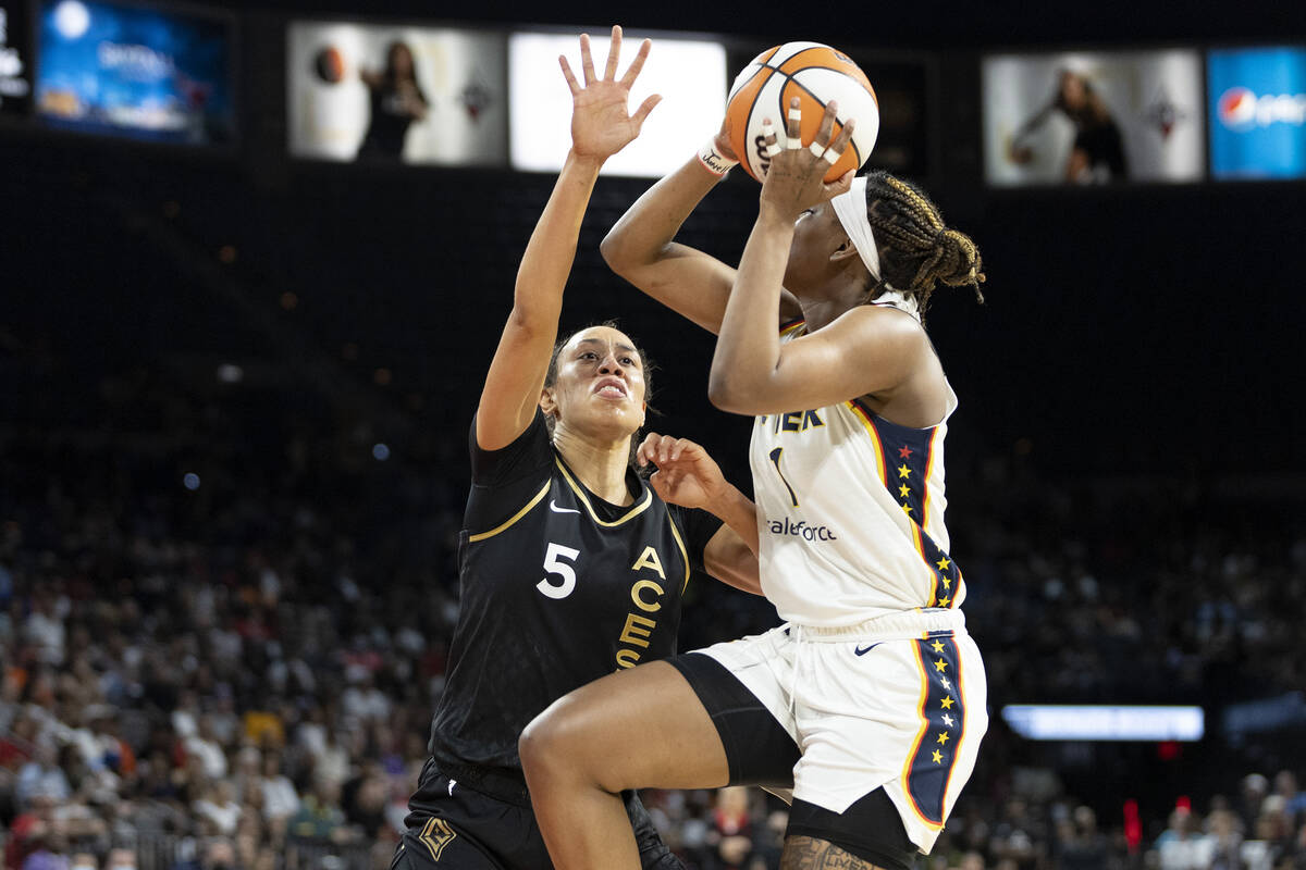 Indiana Fever forward NaLyssa Smith (1) shoots against Las Vegas Aces forward Dearica Hamby (5) ...
