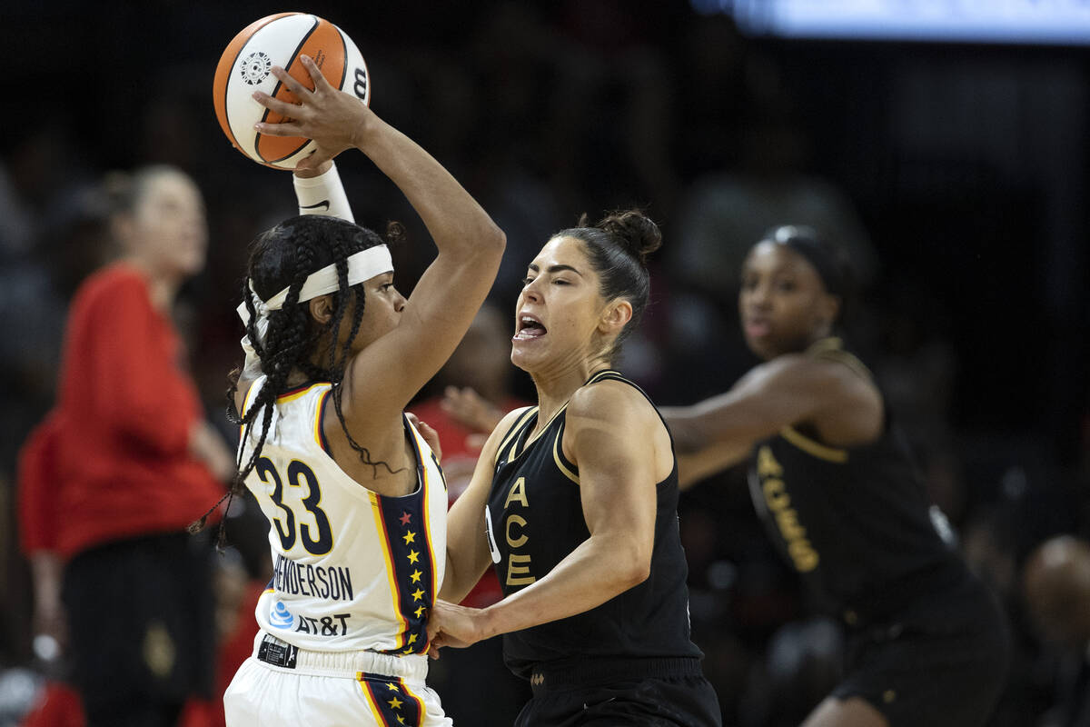 Las Vegas Aces guard Kelsey Plum (10) puts pressure on Indiana Fever guard Destanni Henderson ( ...