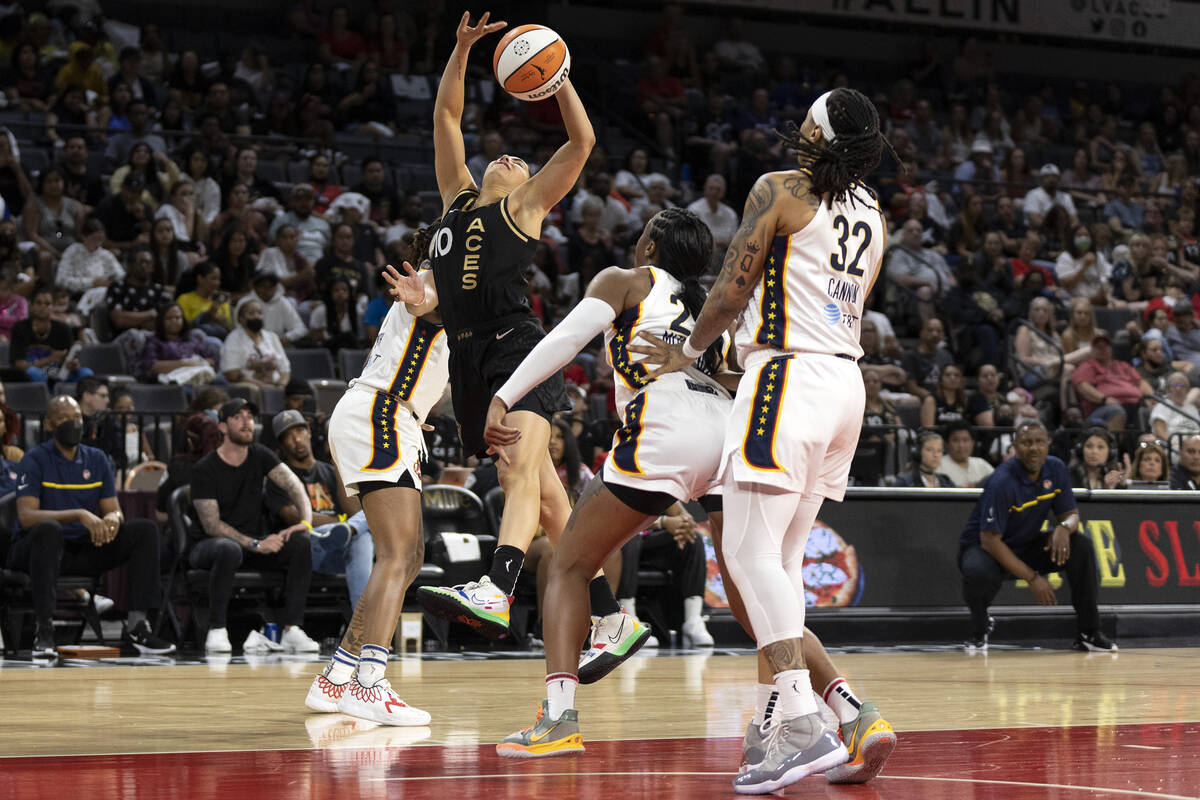 Las Vegas Aces guard Kelsey Plum (10) shoots against Indiana Fever forward NaLyssa Smith, left ...