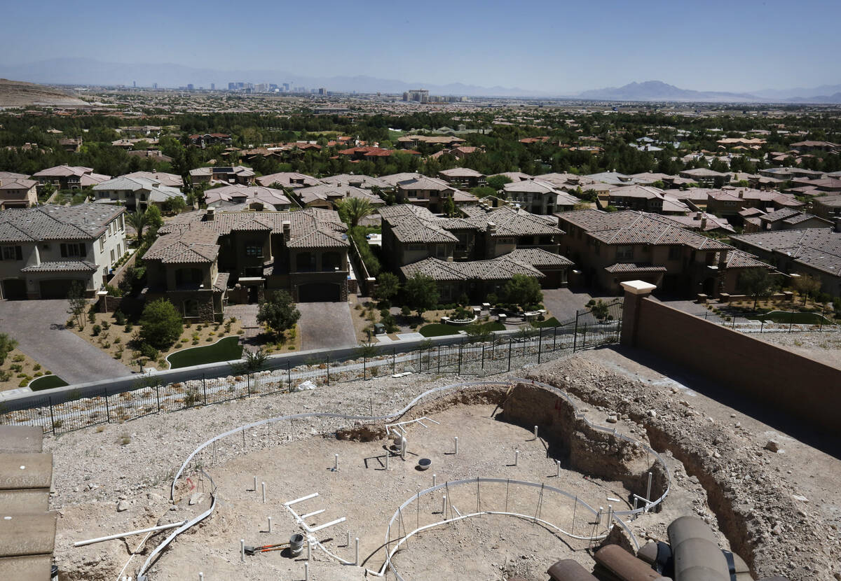 The Las Vegas strip is seen as a swimming pool is under construction in a new house in Southern ...