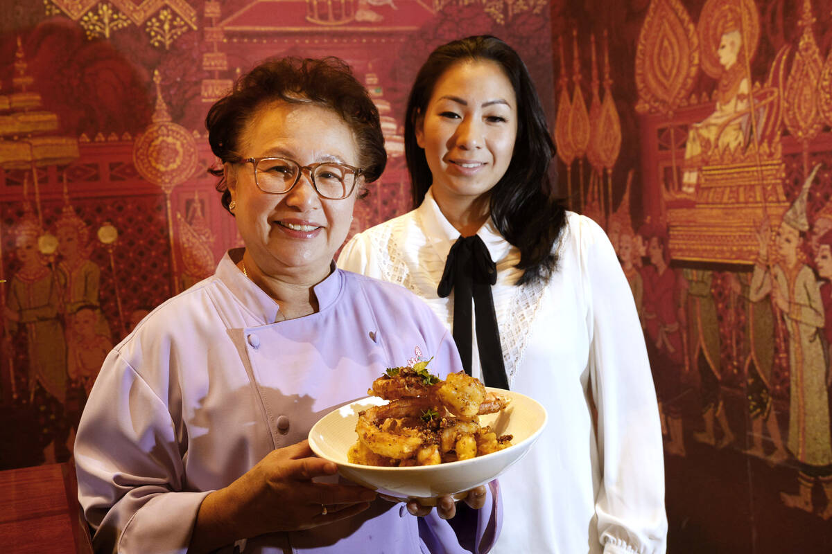Lotus of Siam owner/chef Saipin Chutima, left, shows a dish of garlic prawns with her daughter ...