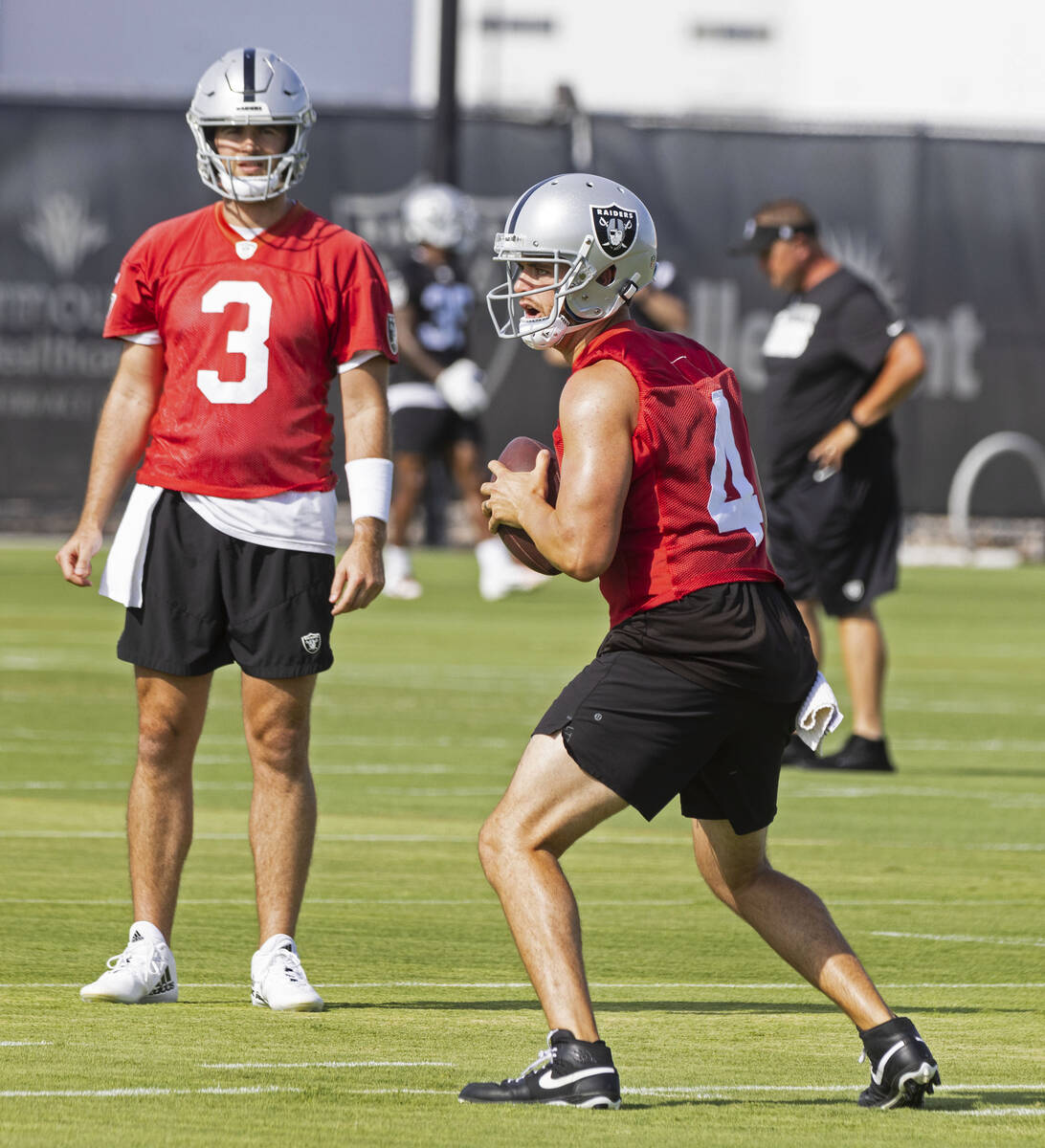 Raiders quarterback Derek Carr (4) prepares to throw the ball as back up quarterback Jarrett St ...