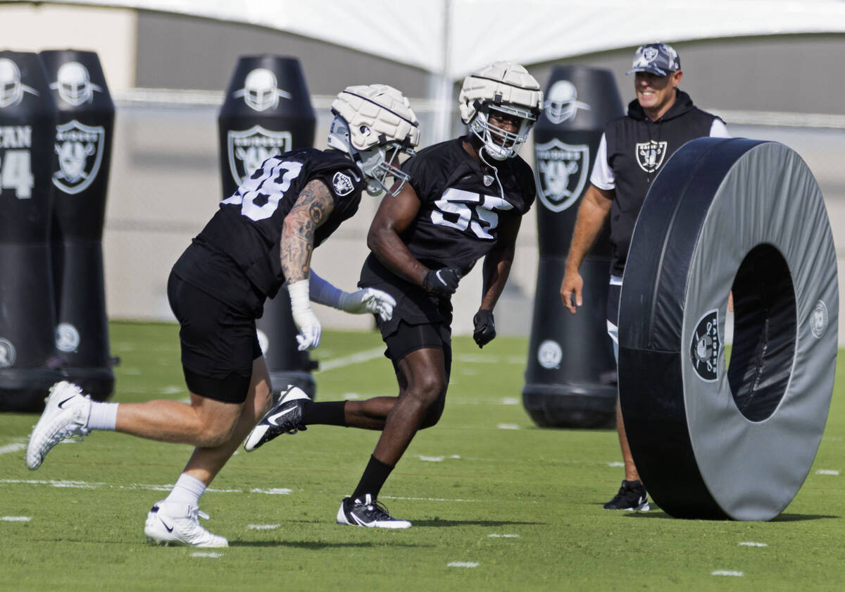 Raiders defensive ends Maxi Crosby (98) and Chandler Jones (55) run the drill during team's pra ...