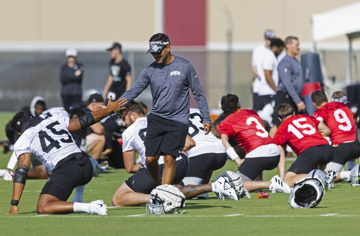 Raiders General Manager Dave Ziegler shakes hand with fullback Jakob Johnson (45) during team's ...