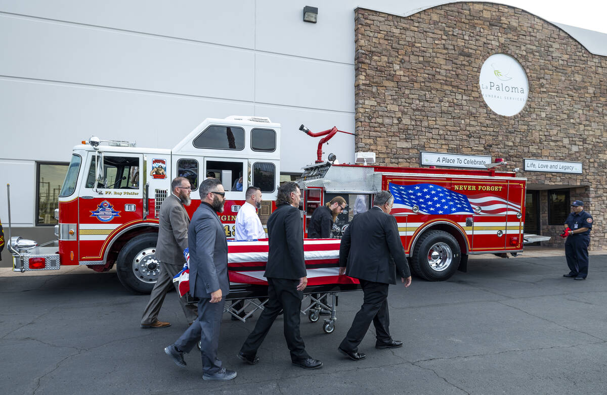 The casket of Las Vegas Fire & Rescue Capt. Dennis Egbert is carried to the Raymond J. Pfei ...
