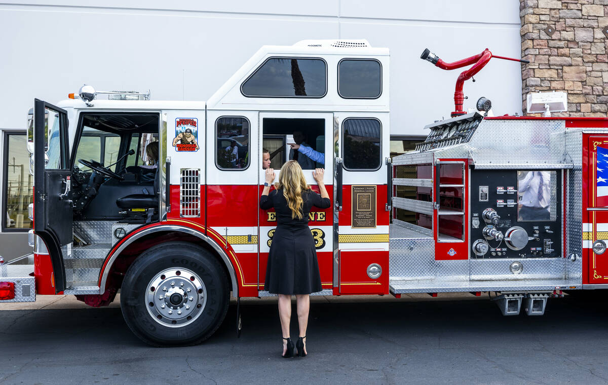 A mom checks on kids who get to ride in the Raymond J. Pfeifer Memorial Caisson on its maiden m ...