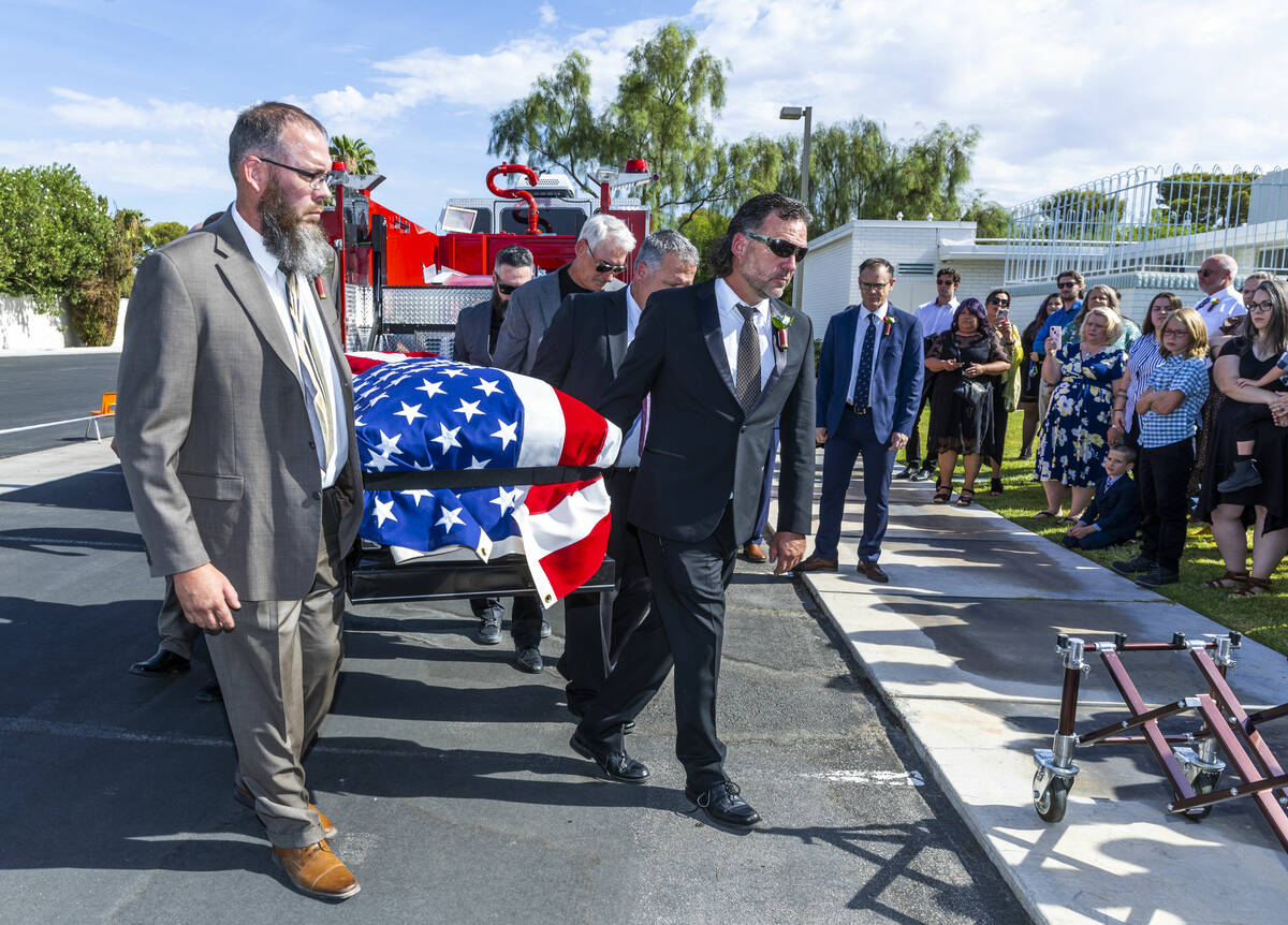 Aaron Egbert, left, with John Egbert, center, and others carry the casket of Las Vegas Fire &am ...