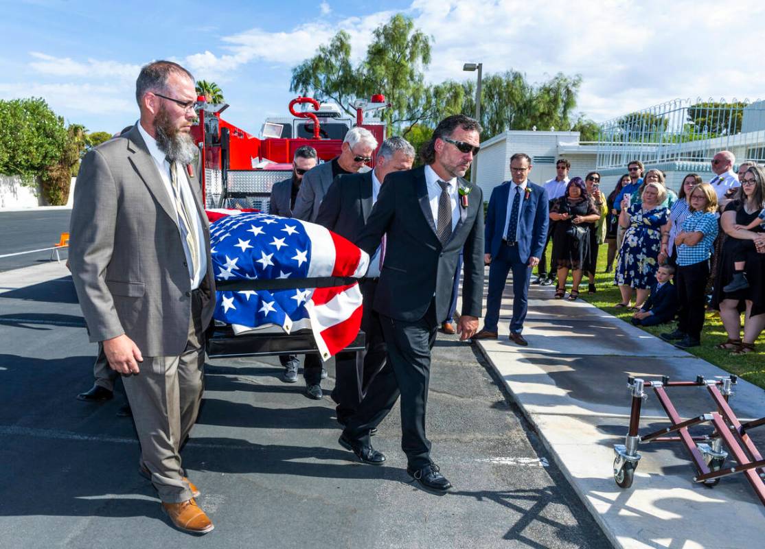 Aaron Egbert, left, with John Egbert, center, and others carry the casket of Las Vegas Fire &am ...