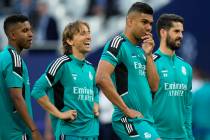 Real Madrid's Luka Modric, 2nd left, and Eder Militao, right, smile during a training session a ...