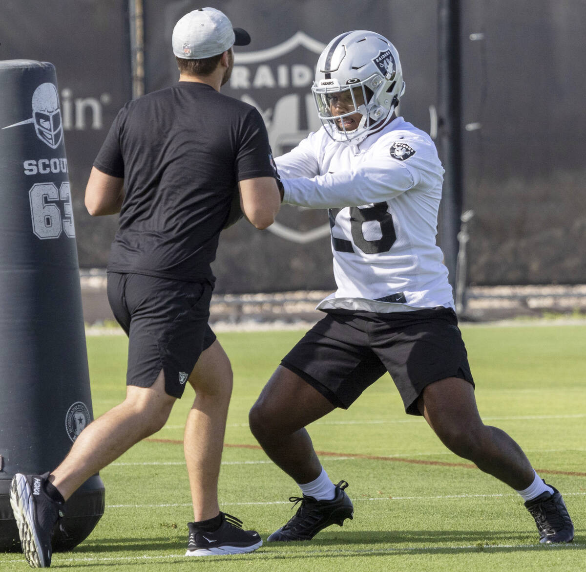 Raiders running back Josh Jacobs (28) runs a drill during training camp practice at the Intermo ...