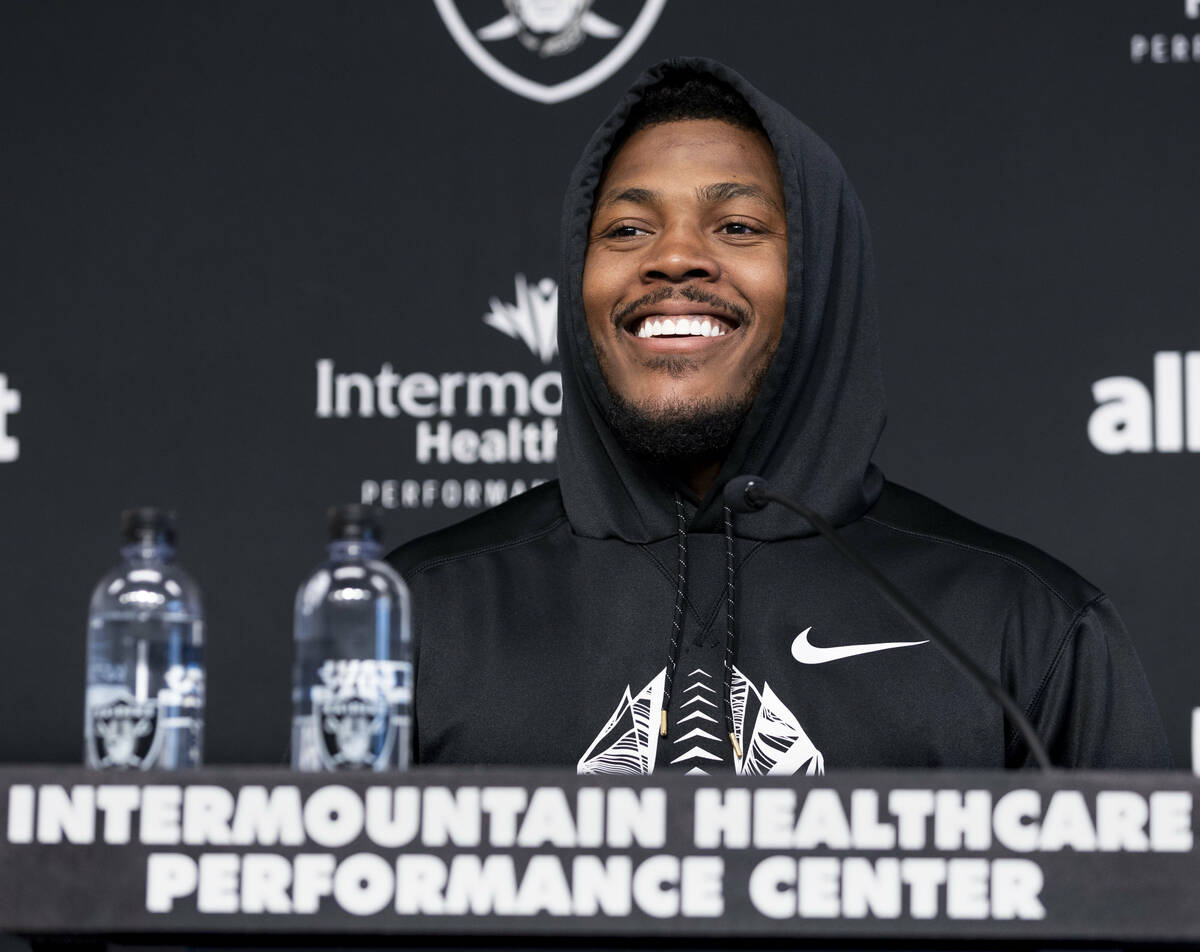 Raiders running back Josh Jacobs (28) smiles during a press conference at training camp in the ...