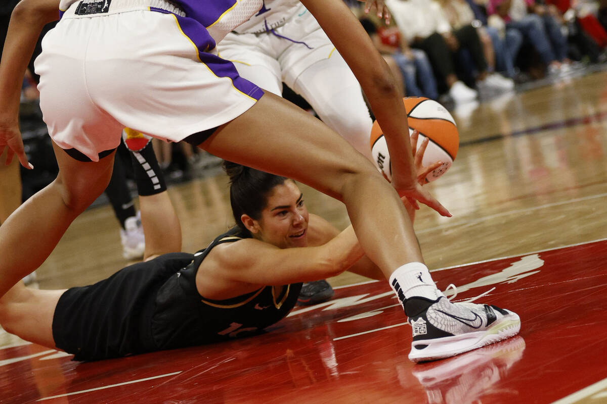 Las Vegas Aces guard Kelsey Plum (10) battle for a loose ball against Los Angeles Sparks playe ...