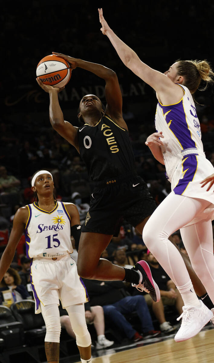 Las Vegas Aces guard Jackie Young (0) shoots over Los Angeles Sparks forward Katie Lou Samuelso ...