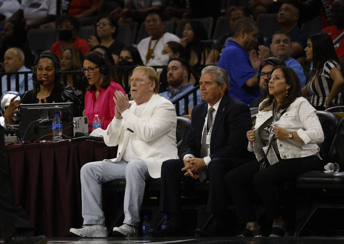 Las Vegas Raiders owner Mark Davis, left, claps his hands during the fourth quarter of a WNBA b ...