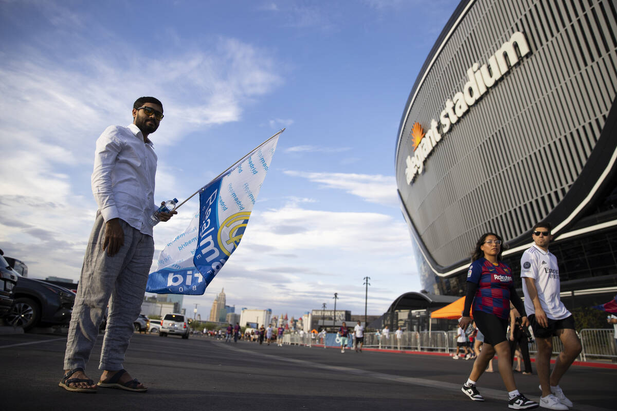 Sajjad Mullahkhel, left, attends a Champions Tour soccer game between Barcelona and Real Madrid ...
