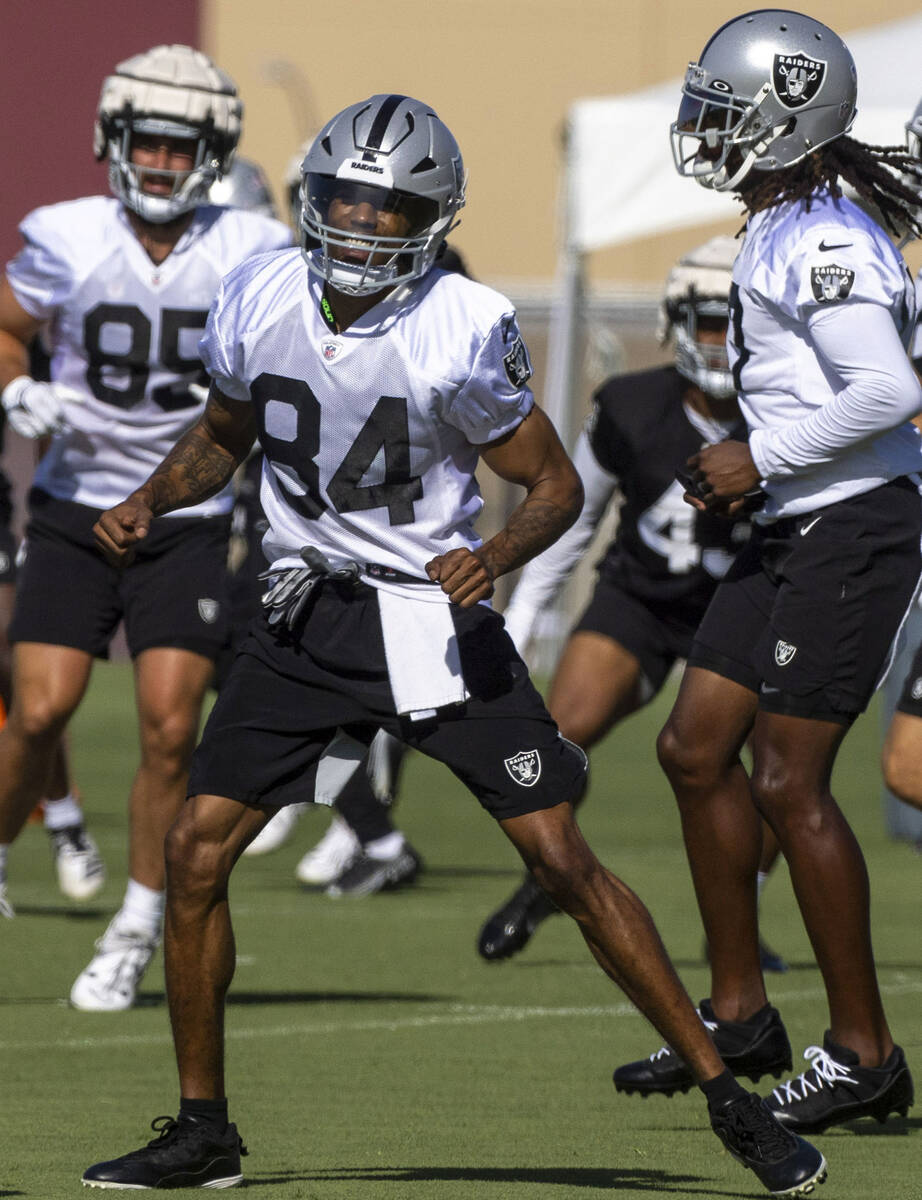 Raiders wide receiver Keelan Cole (84) warms up near wide receiver Davante Adams (17), right, d ...