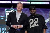 FILE - Rapper Ice Cube, right, poses with NFL Commissioner Roger Goodell during the first round ...