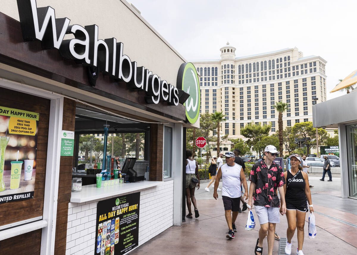 Pedestrians walk past Wahlburgers restaurant on Tuesday, July 26, 2022, on the Las Vegas.strip. ...