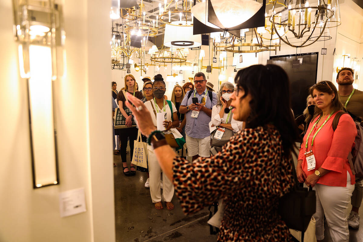Linda Allen, of Linda Allen Designs, leads a tour about lighting at the Summer Market, a furnit ...