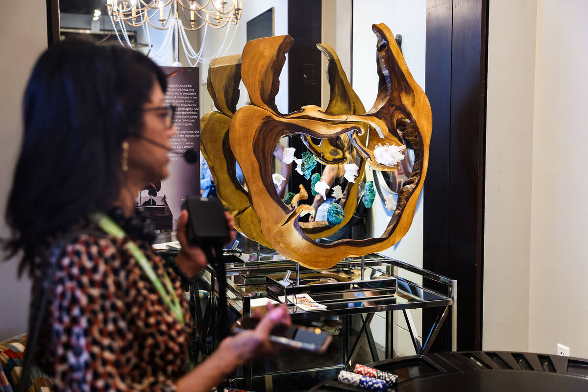 Linda Allen, of Linda Allen Designs, leads a tour about lighting at the Summer Market, a furnit ...