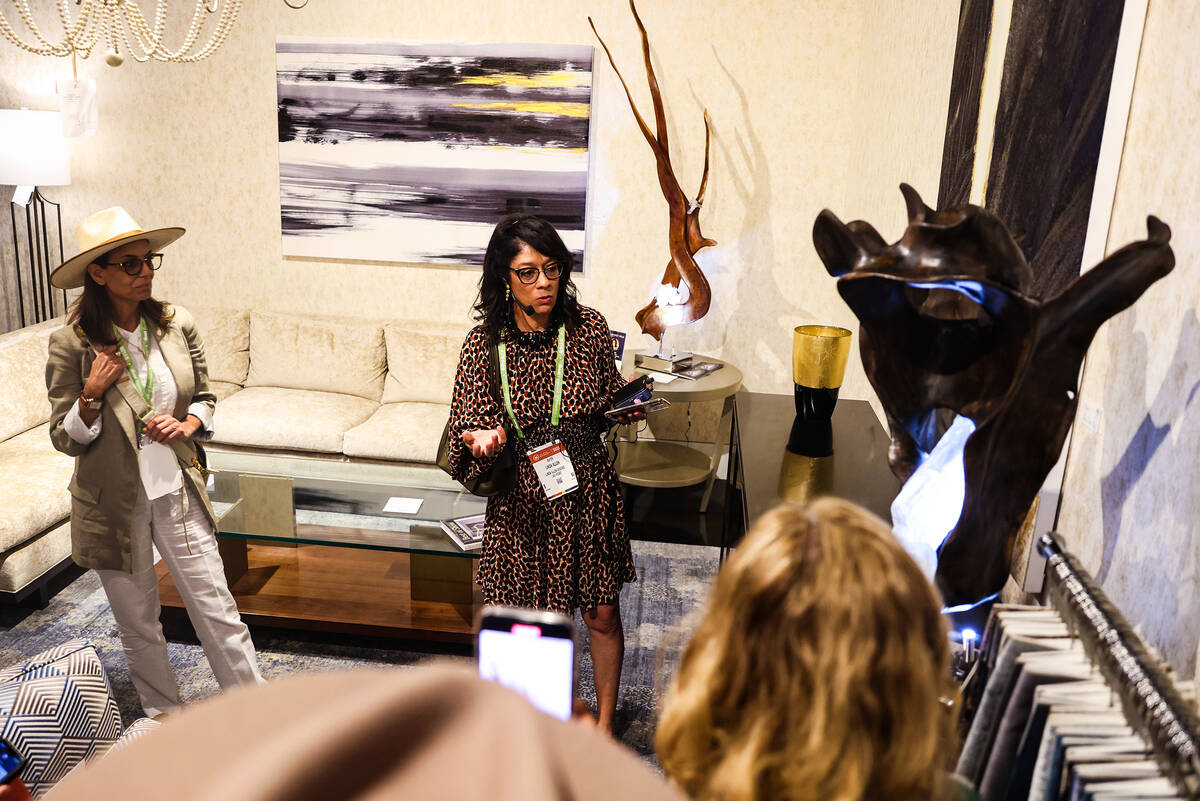 Linda Allen, of Linda Allen Designs, leads a tour about lighting at the Summer Market, a furnit ...