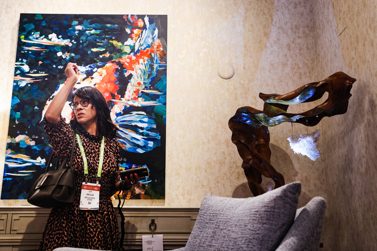 Linda Allen, of Linda Allen Designs, leads a tour about lighting, showcasing the work of Dorit ...