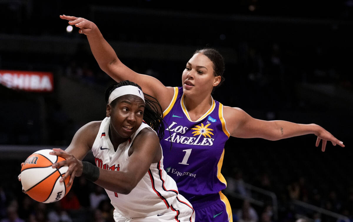 Washington Mystics center Elizabeth Williams, left, gets a rebound next to Los Angeles Sparks c ...
