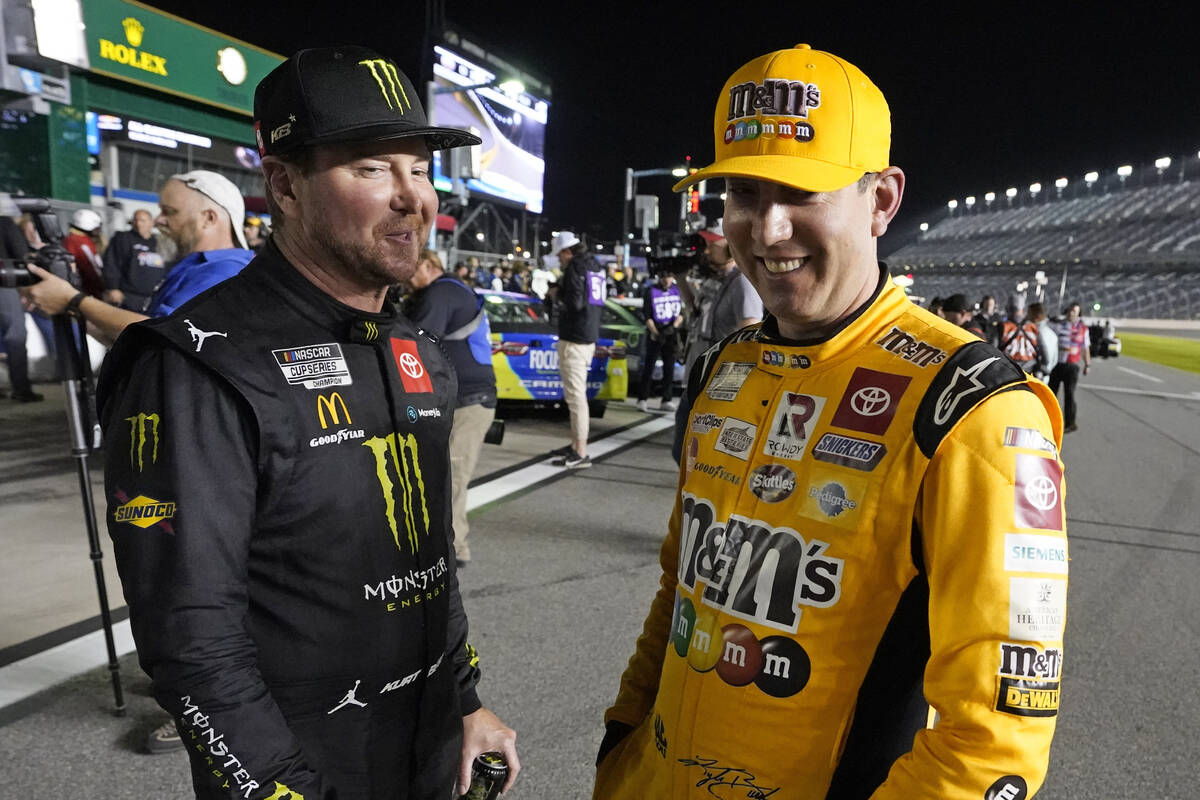 Kurt Busch, left, and Kyle Busch talk on pit road during qualifying for the NASCAR Daytona 500 ...