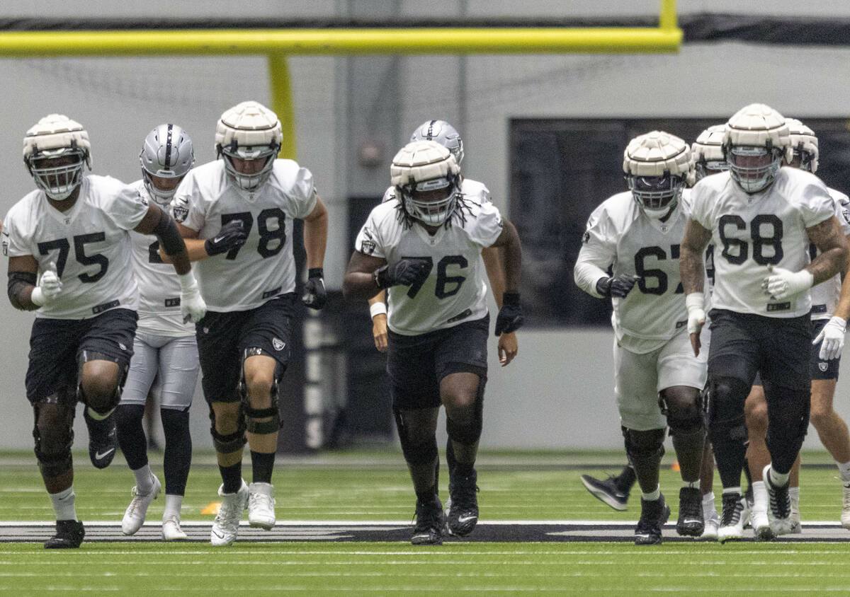 Raiders offensive linemen, from left, Brandon Parker (75), Jackson Barton (78), John Simpson (7 ...